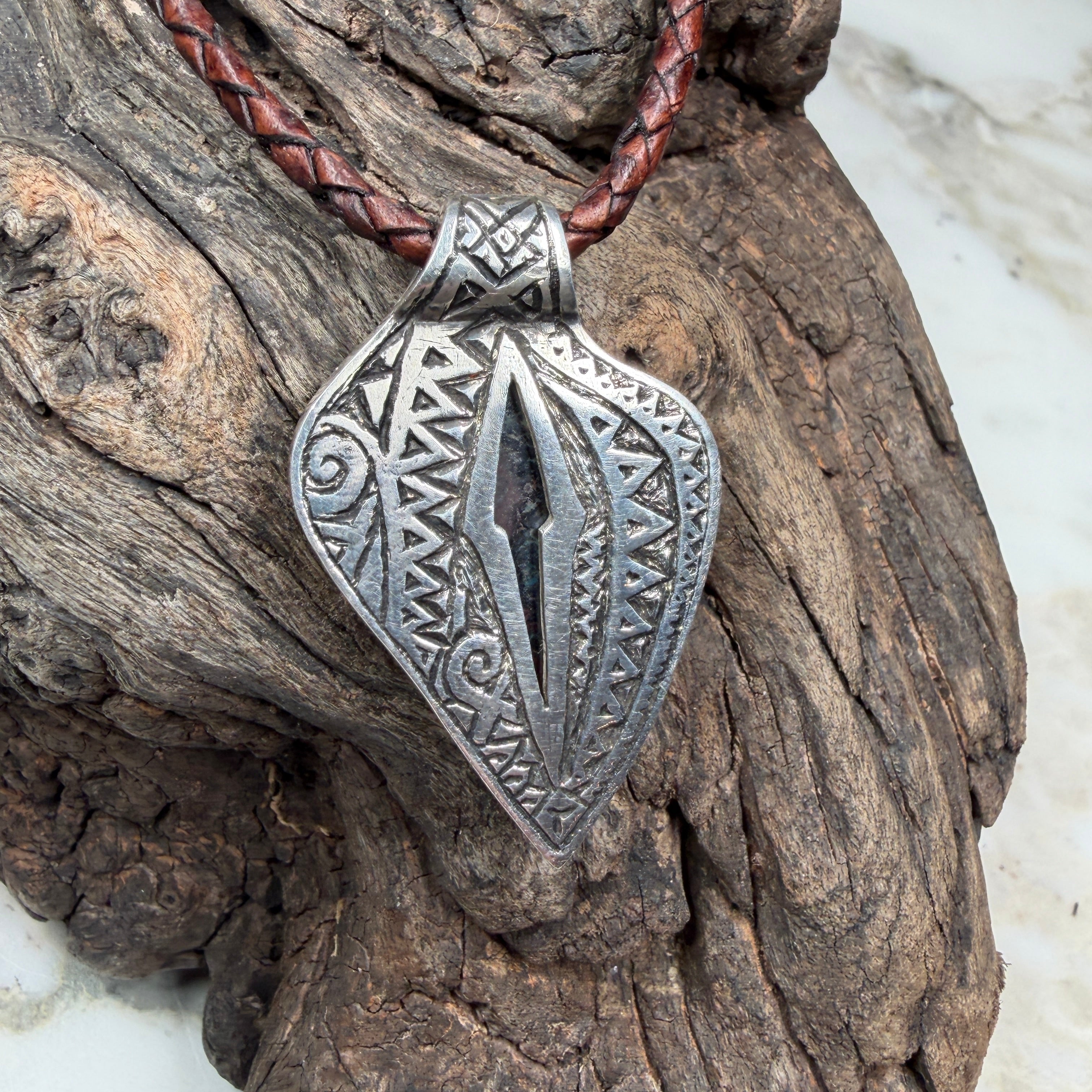 Statement pendant crafted from sterling silver featuring a natural Australian Boulder Opal and detailed engraved backplate.