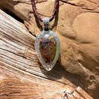 Ancient Tide one-of-a-kind Australian Boulder Opal pendant handcrafted in solid .950 silver by TIDAL OPALS, featuring a natural 31 x 18 mm boulder opal with blue, teal, green, violet, and gold play-of-color, hand-engraved details, and an intricate hand-pierced backplate.