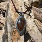 Ancient Tide one-of-a-kind Australian Boulder Opal pendant handcrafted in solid .950 silver by TIDAL OPALS, featuring a natural 31 x 18 mm boulder opal with blue, teal, green, violet, and gold play-of-color, hand-engraved details, and an intricate hand-pierced backplate.