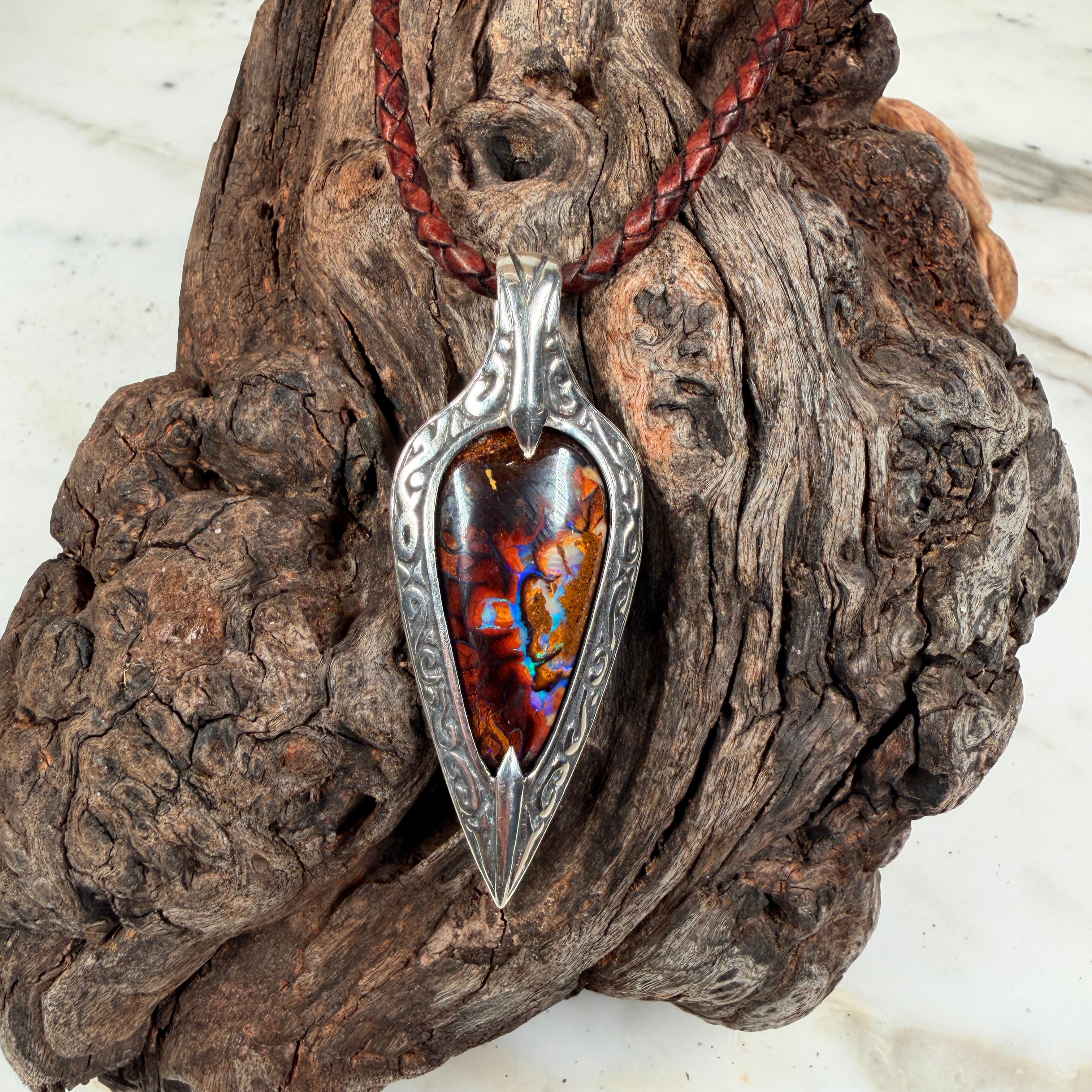 Ember Relic one-of-a-kind Australian boulder opal pendant with electric blue, orange and red color set in engraved sterling silver.