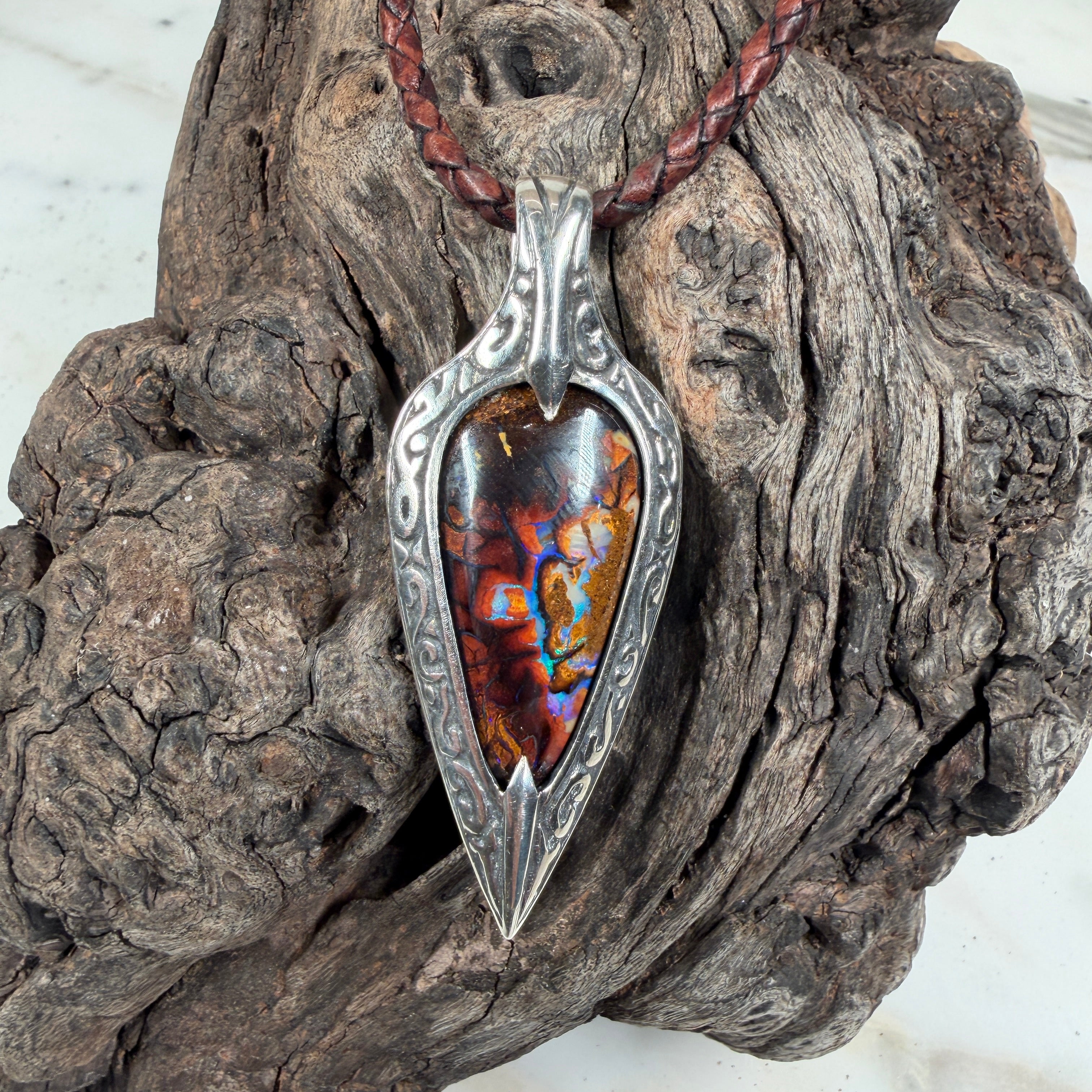 Ember Relic one-of-a-kind Australian boulder opal pendant with electric blue, orange and red color set in engraved sterling silver.