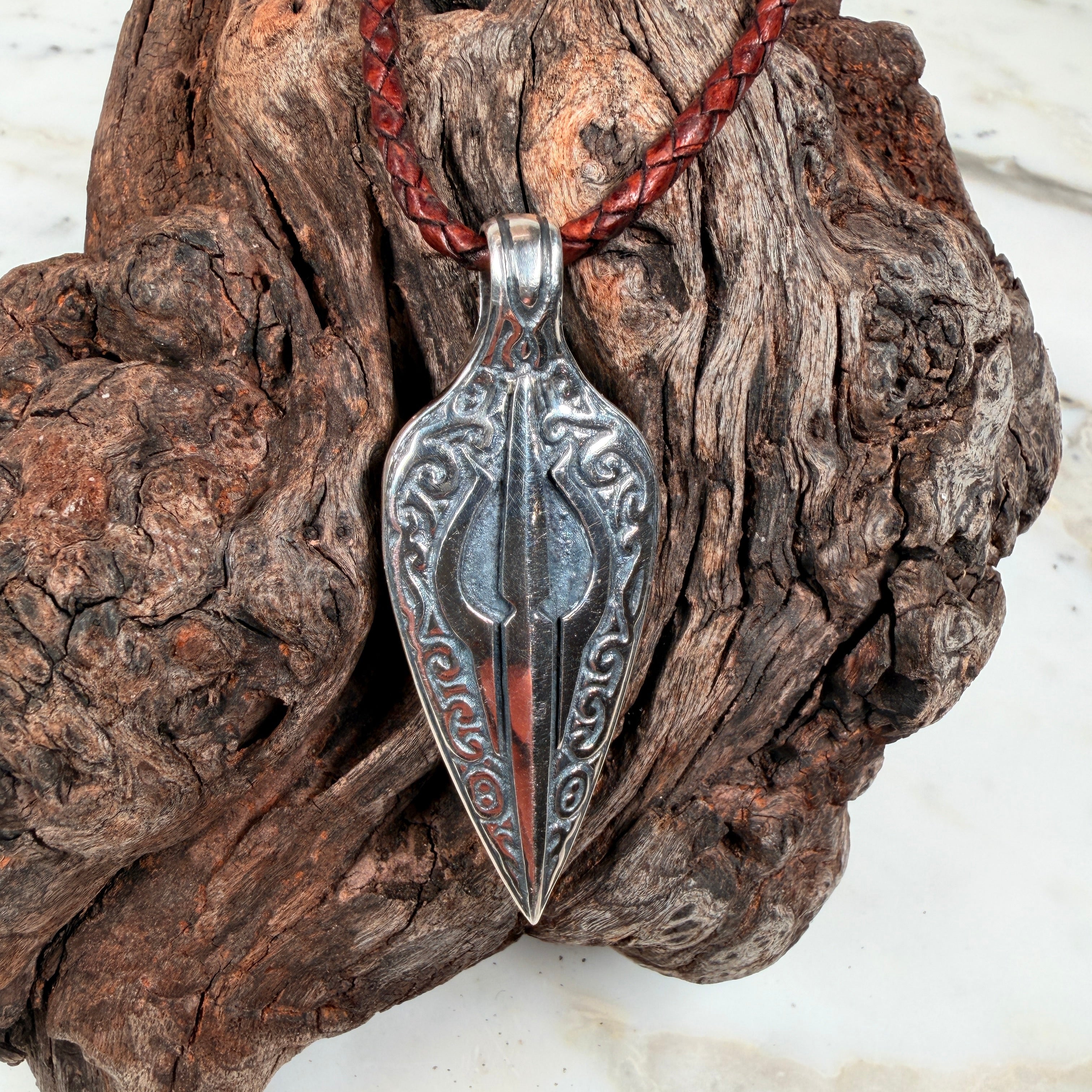 Back of the Ember Relic boulder opal pendant showing its detailed hand-cut and engraved sterling silver backplate.