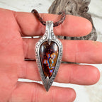 Ember Relic one-of-a-kind Australian boulder opal pendant with electric blue, orange and red color set in engraved sterling silver.