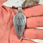Back of the Ember Relic boulder opal pendant showing its detailed hand-cut and engraved sterling silver backplate.