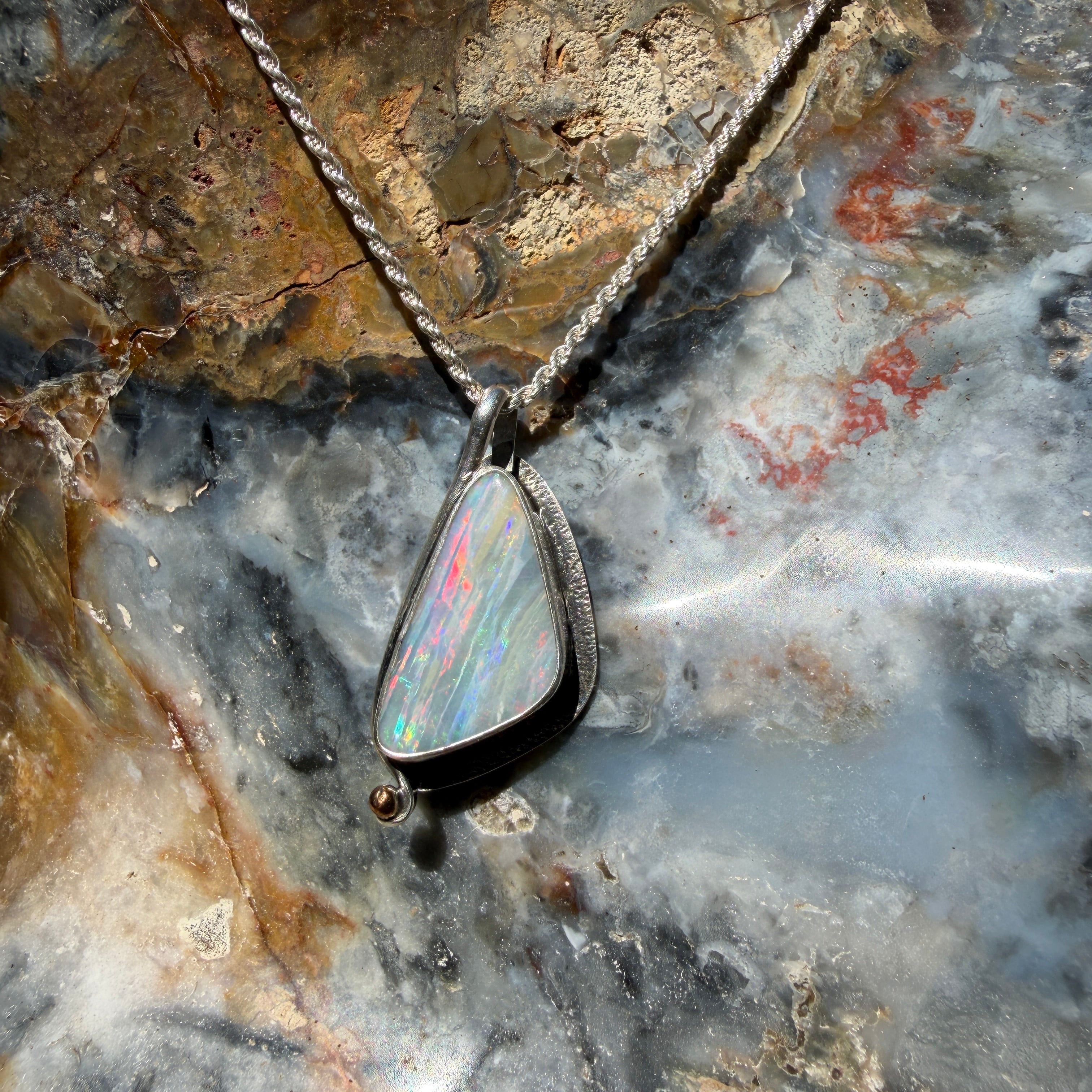 Fine jewelry pendant featuring a 24 × 12 mm genuine Australian Boulder Opal