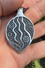 Natural Australian boulder opal in textured sterling silver with braided leather cord