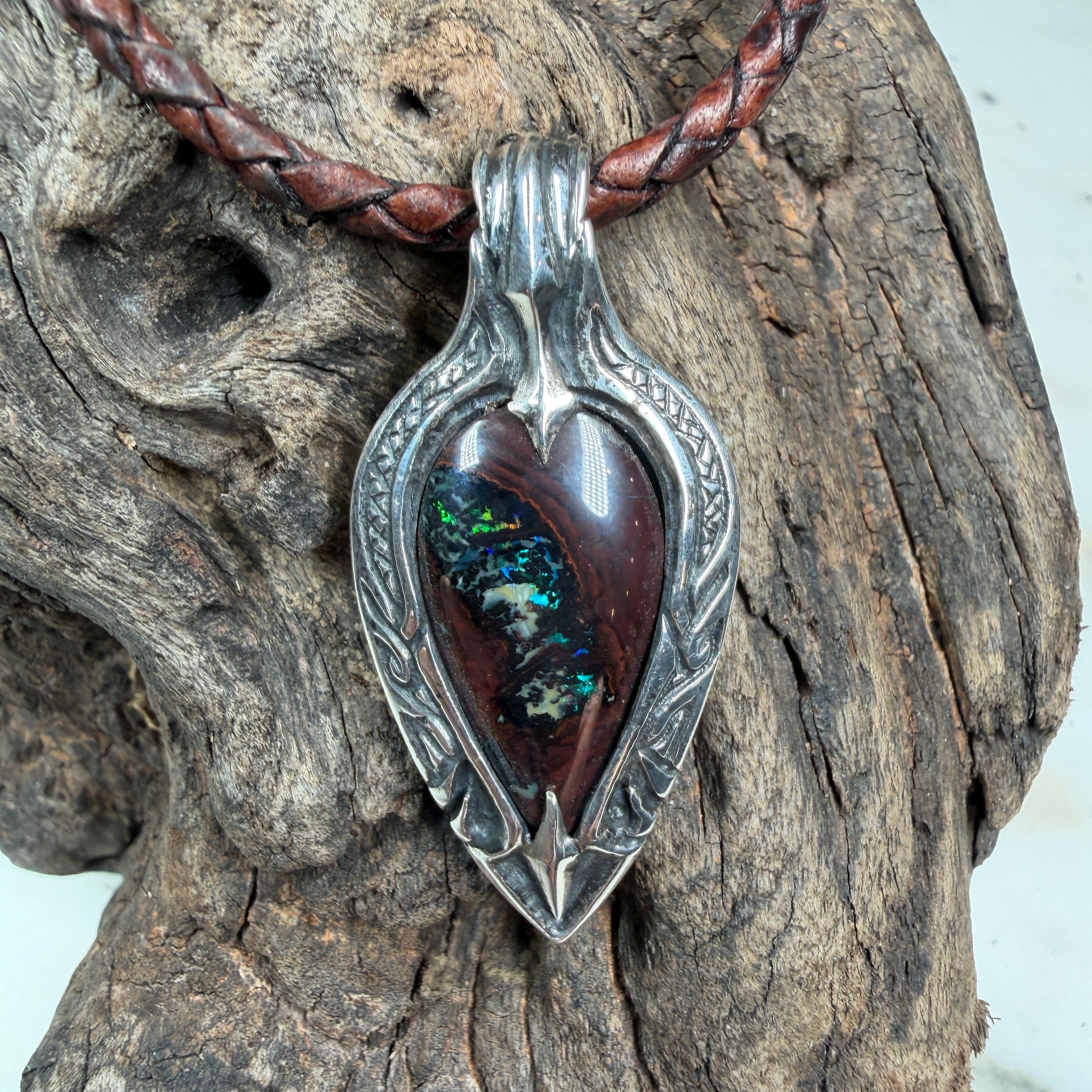 Luxury Australian Boulder Opal statement pendant featuring brilliant emerald green, teal, and golden fire in sterling silver.