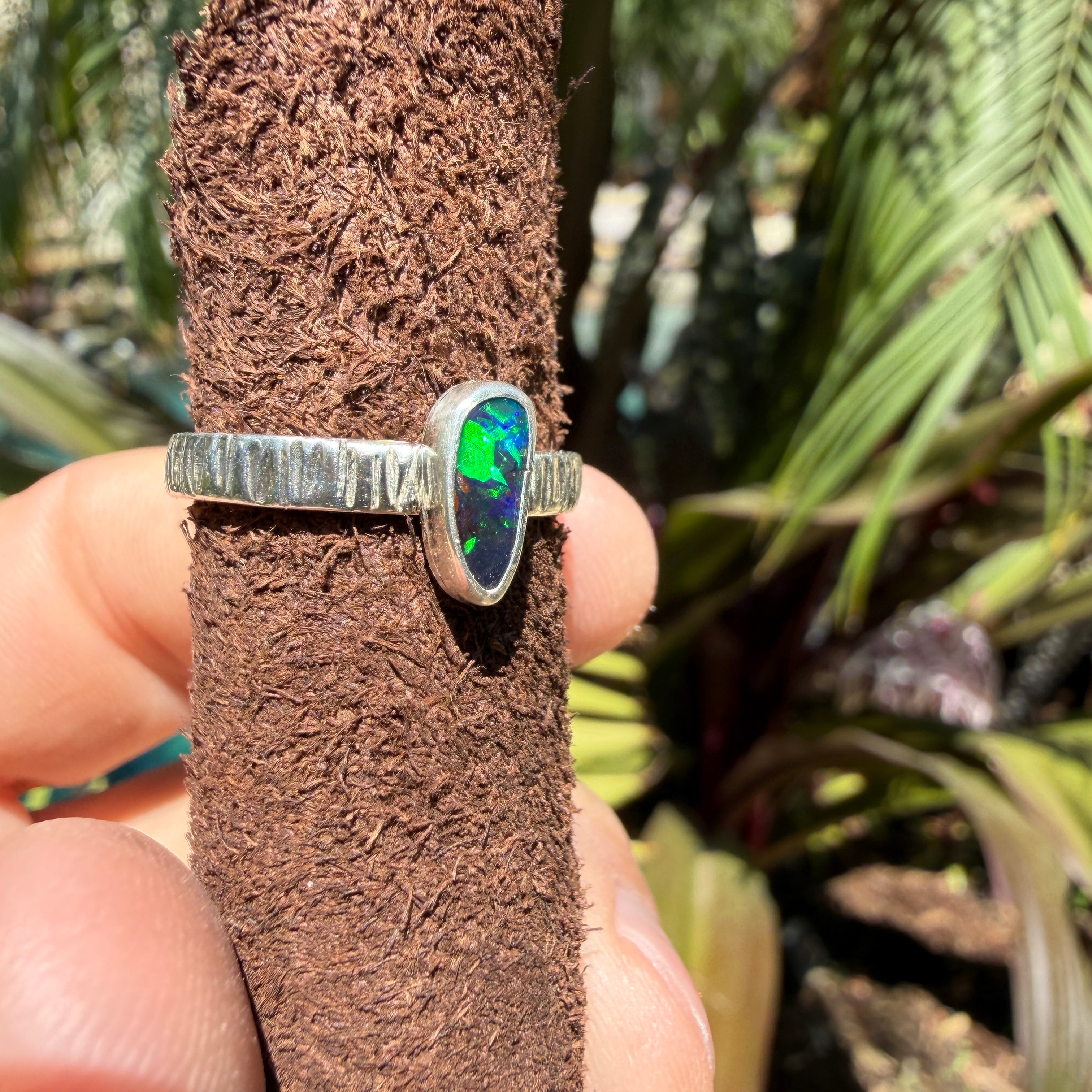 Natural Boulder Opal ring with deep blue color and small flashes of bright green in sterling silver.