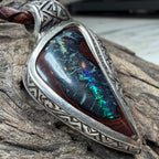 Ocean-inspired artisan pendant featuring a natural Boulder Opal in handcrafted sterling silver with geometric engraving.