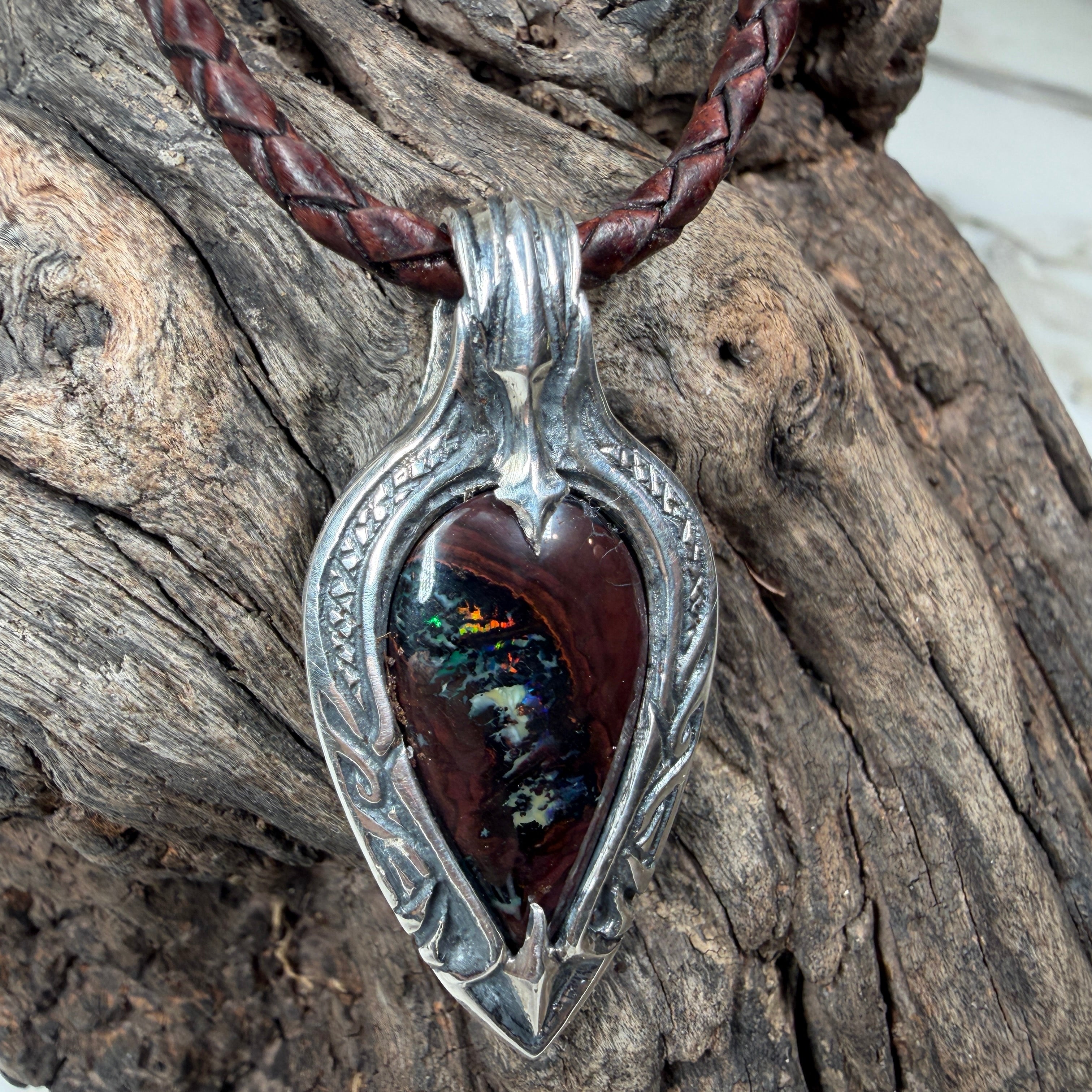 One-of-a-kind Australian Boulder Opal pendant featuring emerald green, golden fire, and cobalt blue in a handcrafted sterling silver setting.