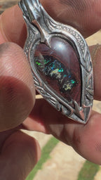 Ocean-inspired Australian Boulder Opal pendant with handcrafted sterling silver, Polynesian-inspired engraving, and trident backplate.