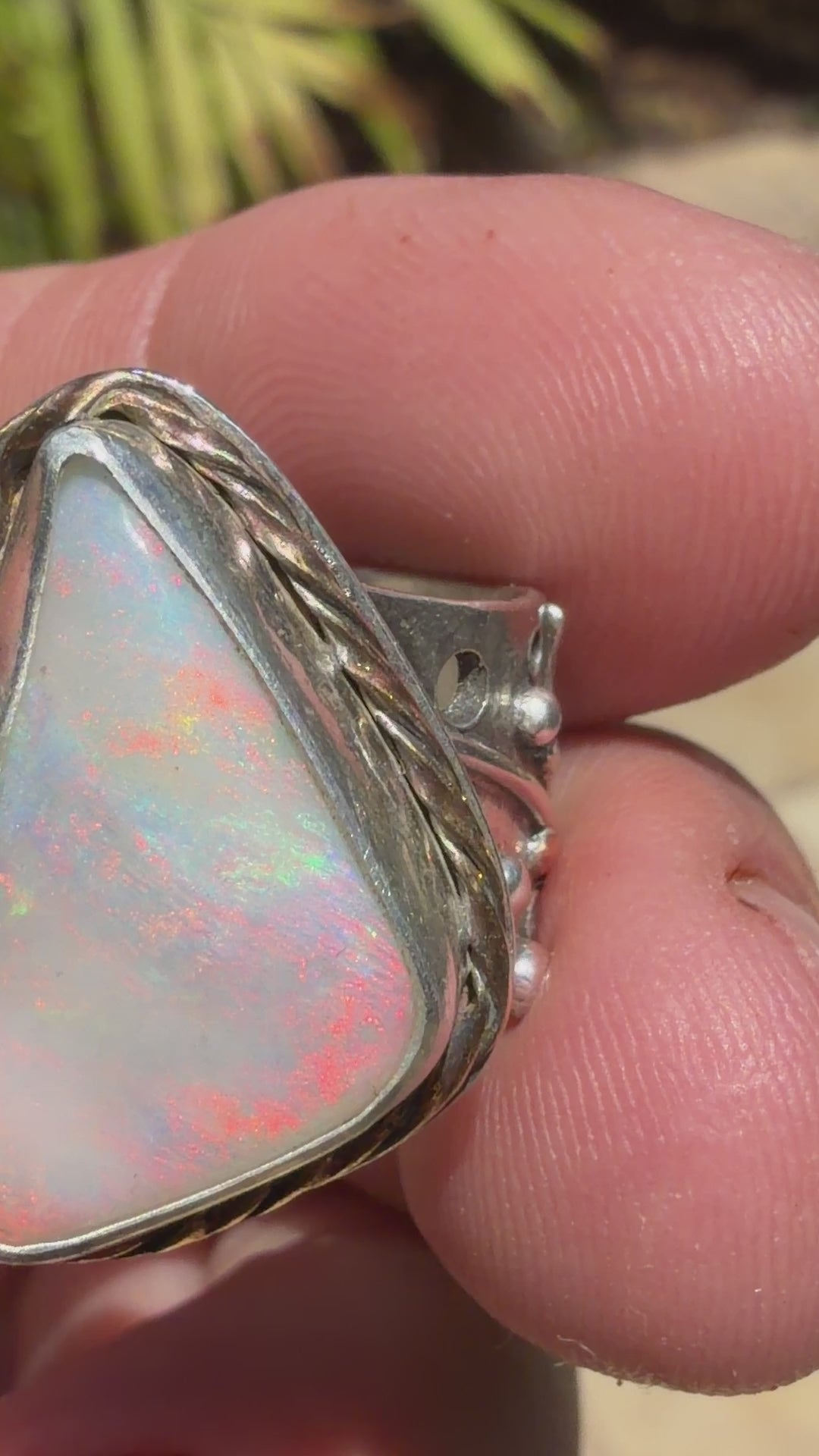Celestial Tide handcrafted Australian crystal opal ring in .925 sterling silver with a 14K gold rope bezel, gold accents, and sculpted starfish.