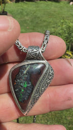 Handcrafted sterling silver pendant featuring a natural Australian Boulder Opal with emerald green and blue flashes.