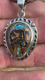 Australian Boulder Opal pendant inspired by tidal channels, featuring unique natural patterns and artisan sterling silver craftsmanship.