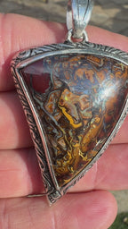 Natural Australian Boulder Opal jewelry showcasing organic ironstone patterns in a handcrafted silver setting.