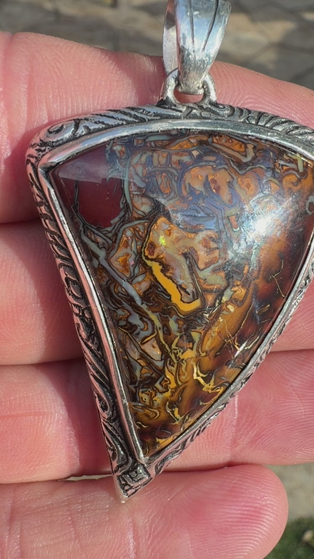 Natural Australian Boulder Opal jewelry showcasing organic ironstone patterns in a handcrafted silver setting.