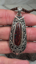 Natural Australian Boulder Opal pendant with weathered ironstone patterns and vibrant blue-green flashes.