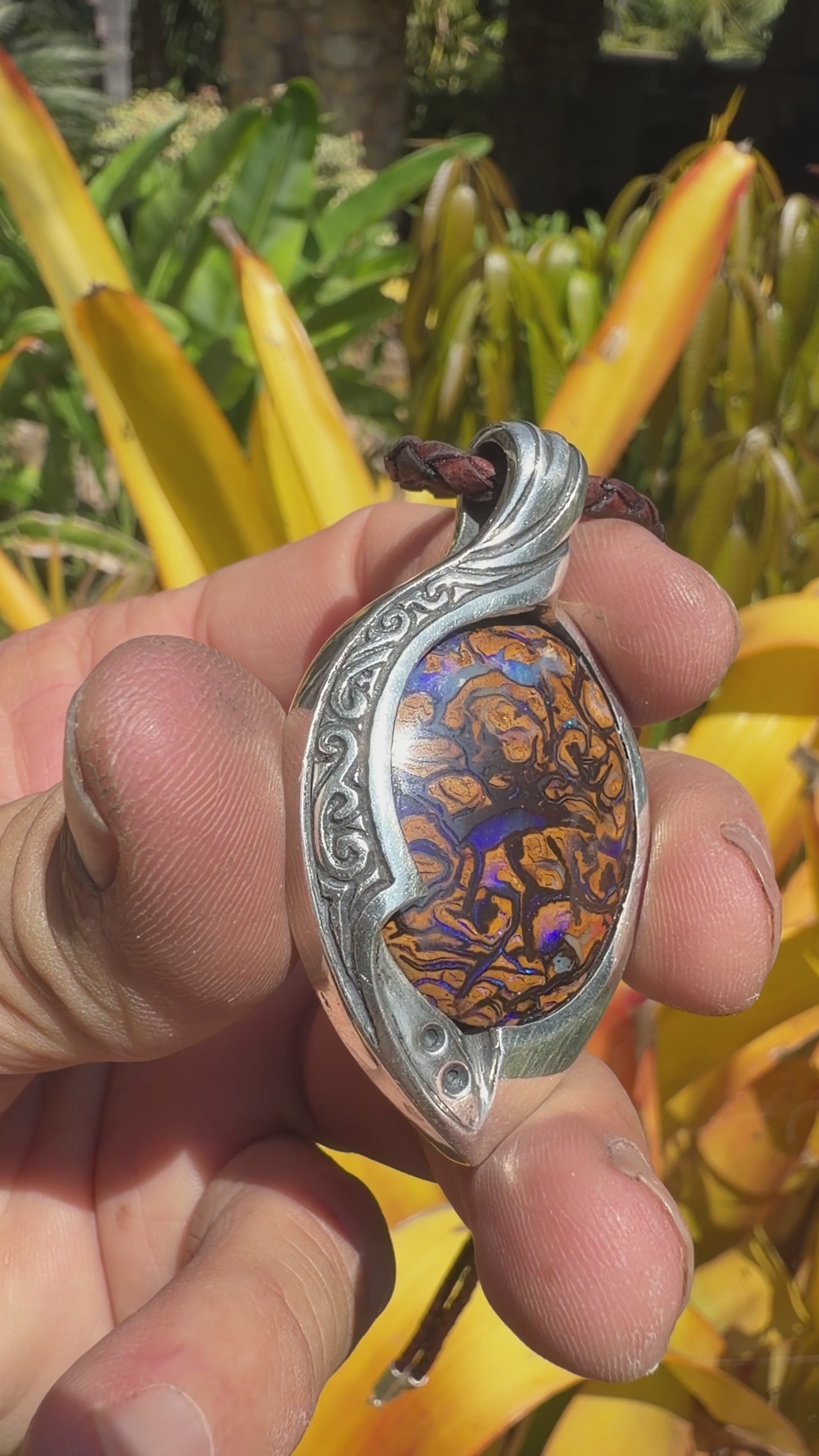 Teardrop Australian boulder opal pendant with electric blue and golden-brown tones