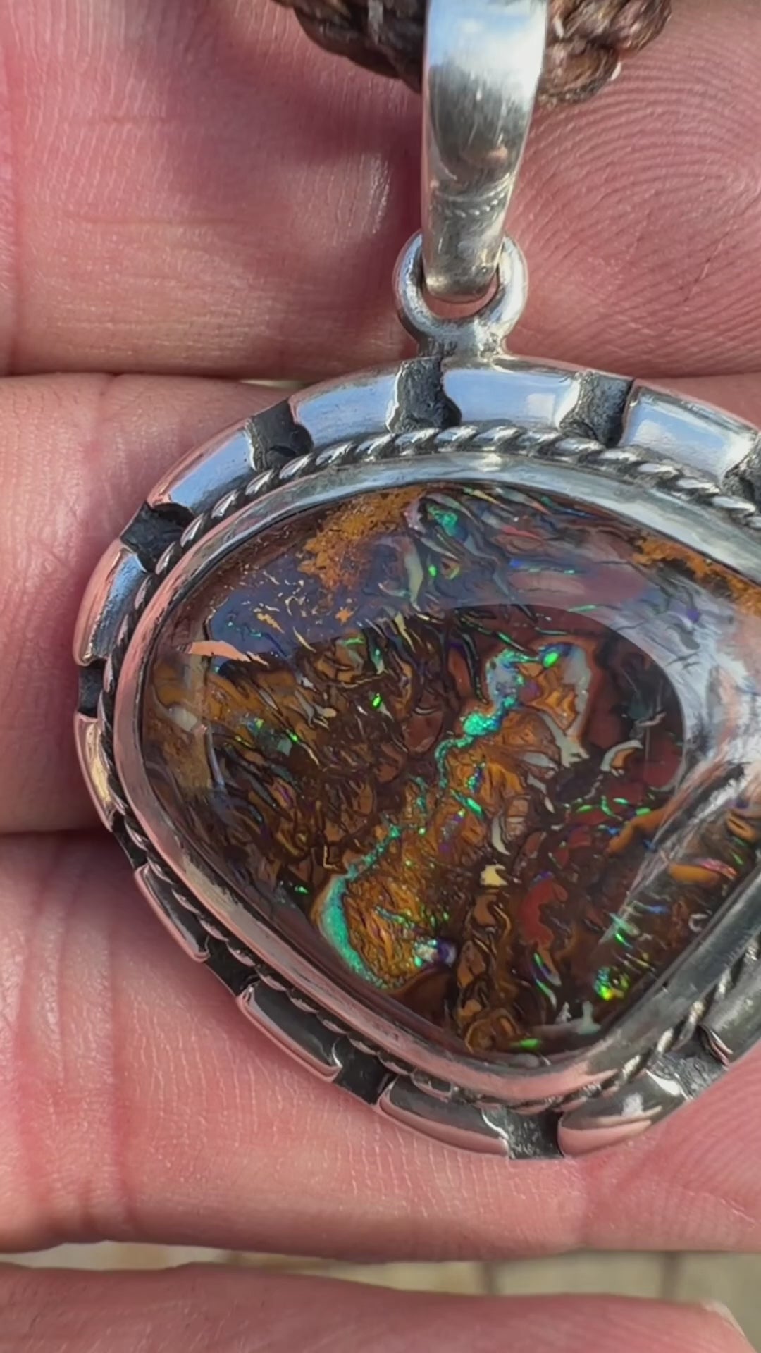 Sea Forge Australian Boulder Opal Pendant handcrafted in sterling silver featuring a genuine 20 × 24 mm Boulder Opal with brilliant blue, green, turquoise, and copper flashes.
