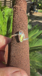 Simple everyday sterling silver ring with a natural Australian boulder opal displaying bright blue, green, and turquoise colors.