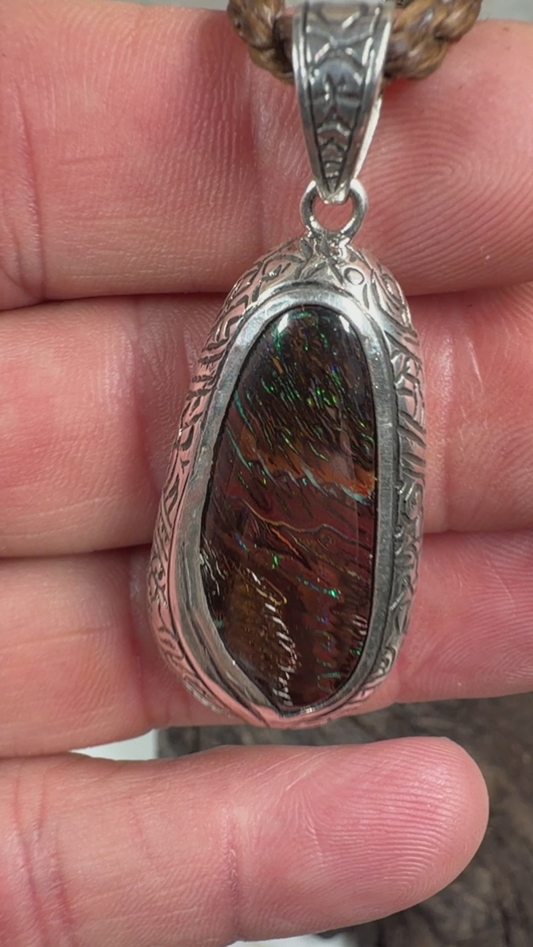 Artisan Australian Boulder Opal pendant with brown ironstone, blue flashes, and handcrafted sterling silver setting.