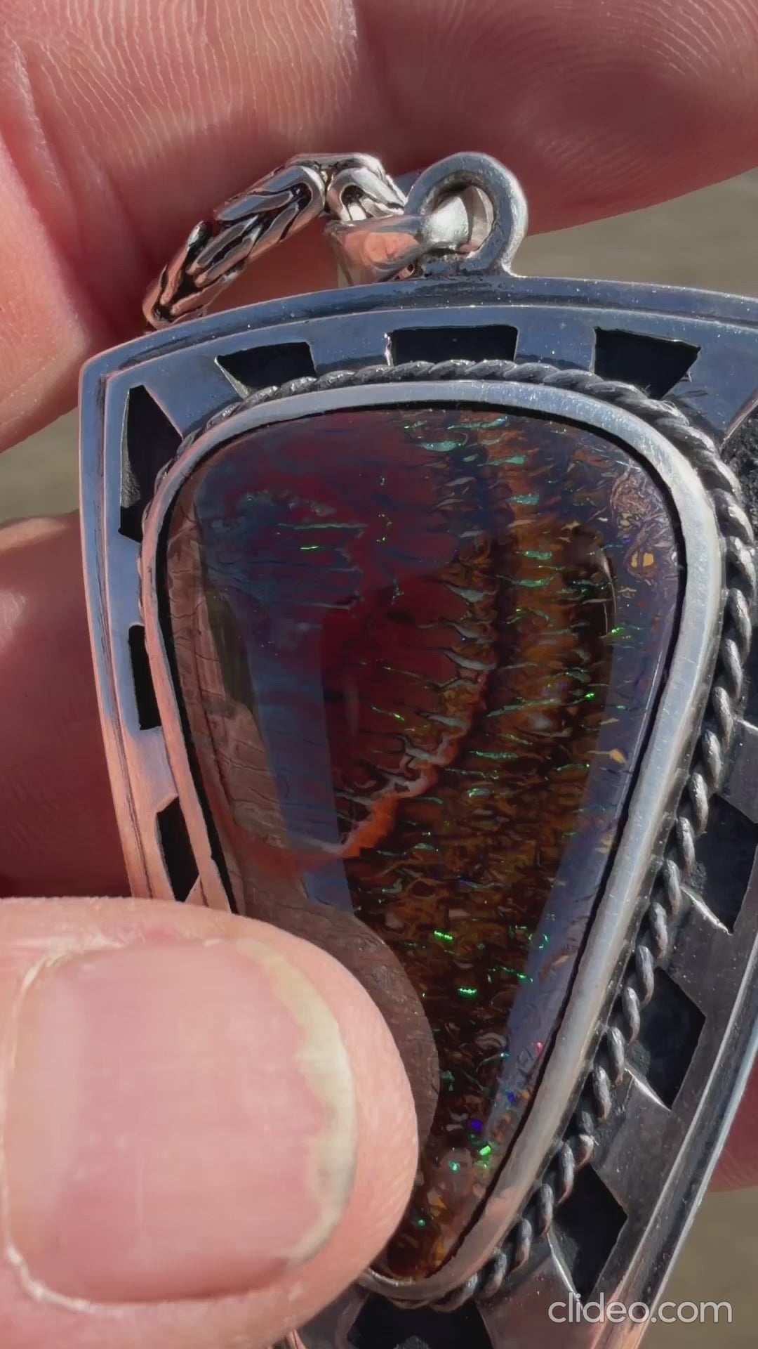 Iron Bastion shield pendant featuring a 38 × 24 mm Australian Koroit Boulder Opal set in solid .925 sterling silver.